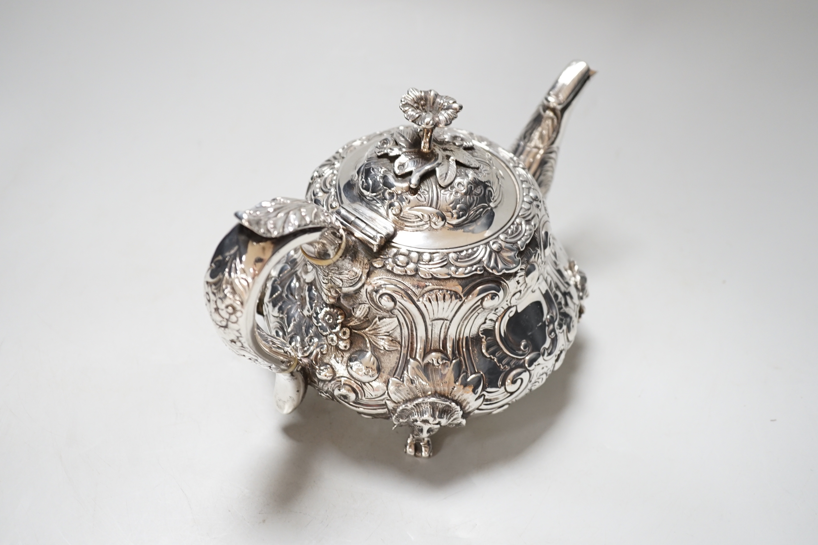 A William IV silver teapot, with floral knop, scroll and mask decoration, makers mark rubbed, London 1831, gross 617 grams, CITIES Submission reference NX44TQHA